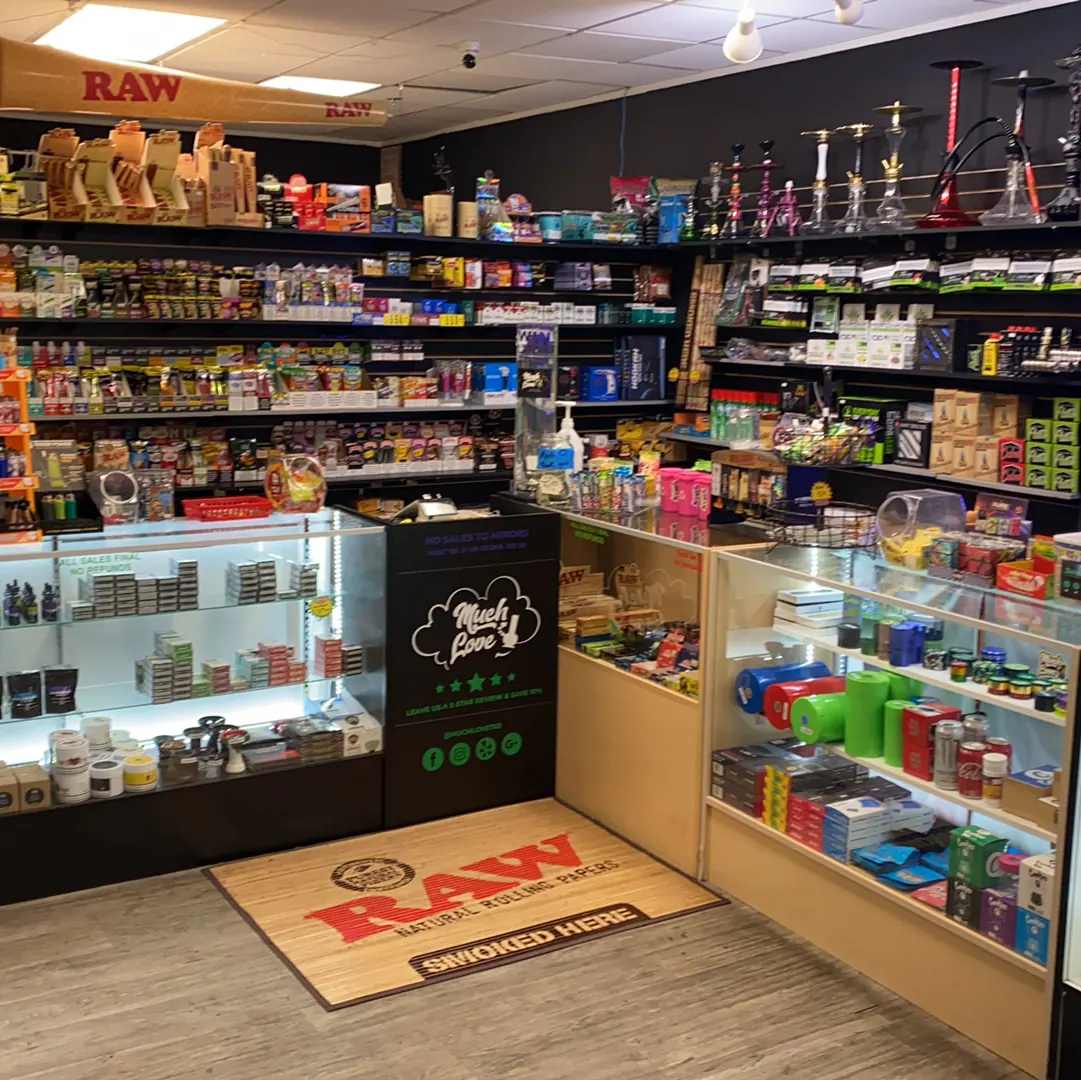 Rolling papers, hookahs and lit glass cases behind the Much Love counter