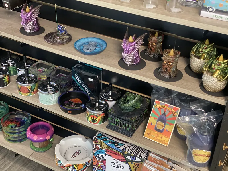 Ashtrays, grinders and dragon incense burners on the shelf