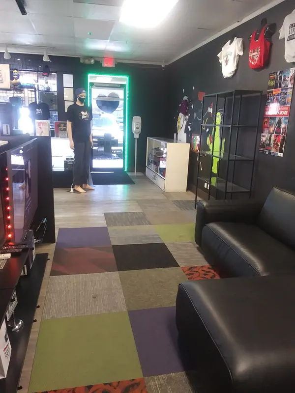 Colourful carpet and leather lounge seating inside Much Love