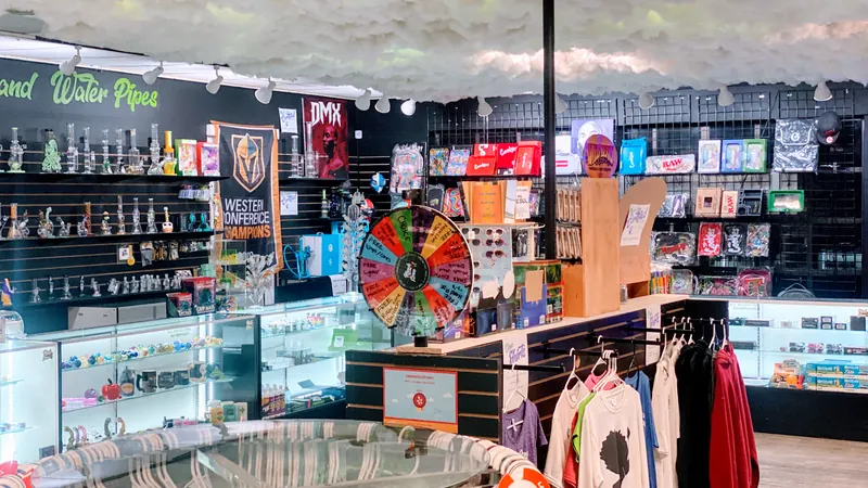 Inside Much Love: the glass wall, cloud ceiling, prize wheel and custom shirts