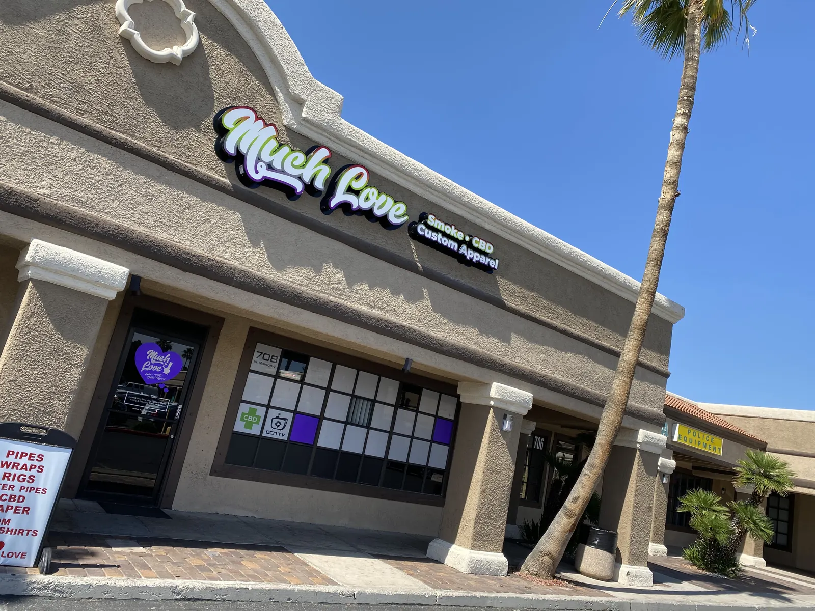 Much Love storefront on North Rainbow Blvd with its Smoke, CBD and Custom Apparel sign